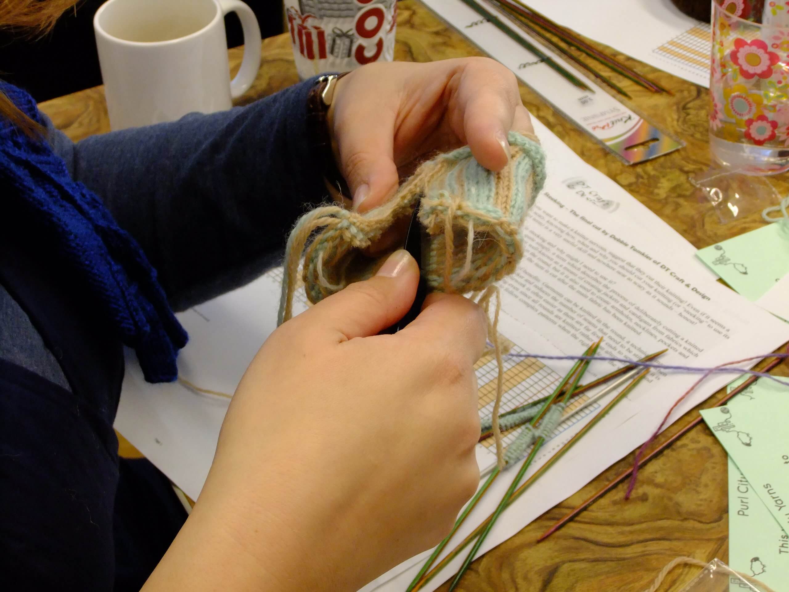 Student steeking (cutting) a sample on a workshop with Debbie Tomkies of DT Craft & Design